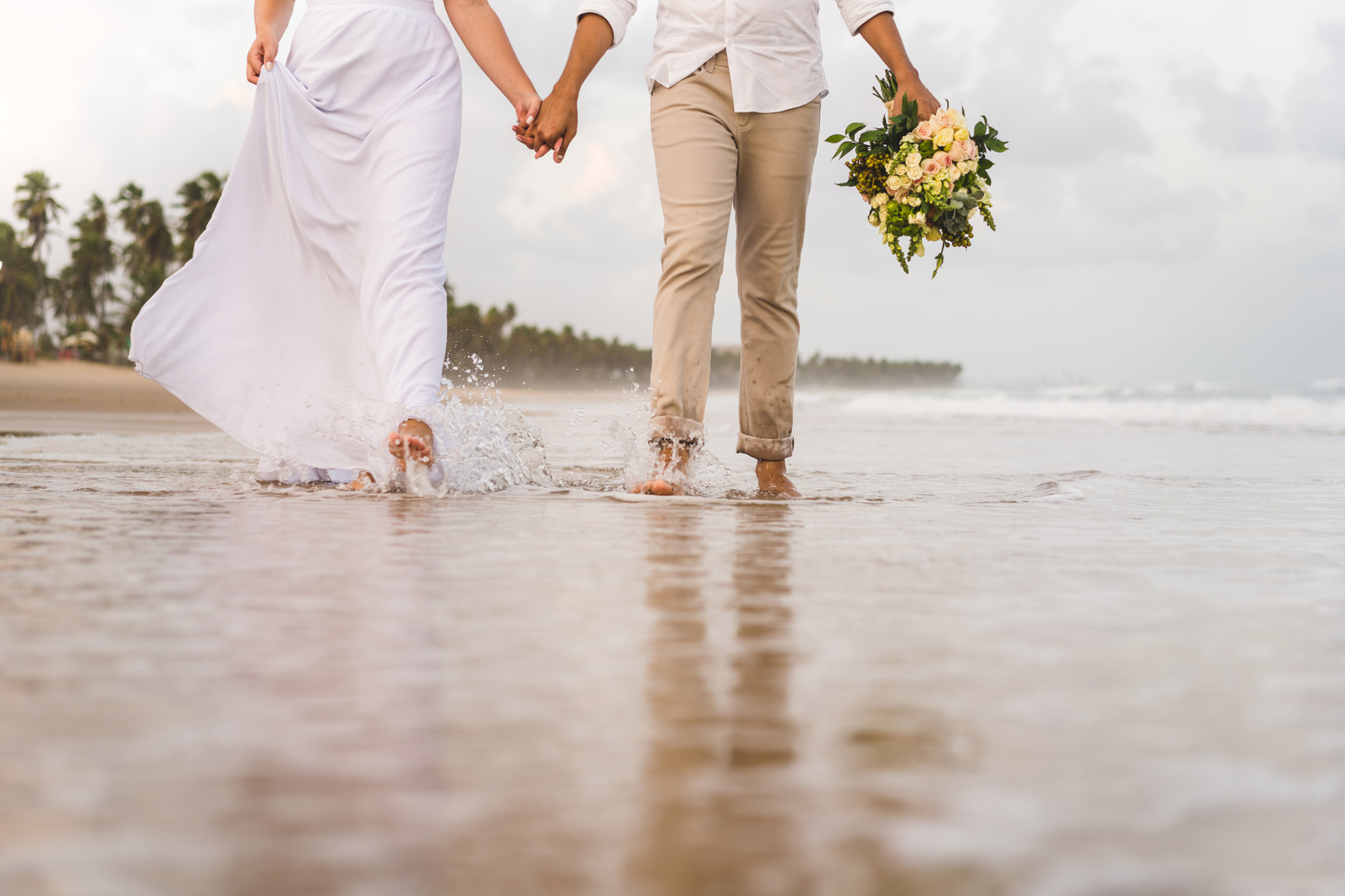 Elopement wedding, couple walking on sea foam